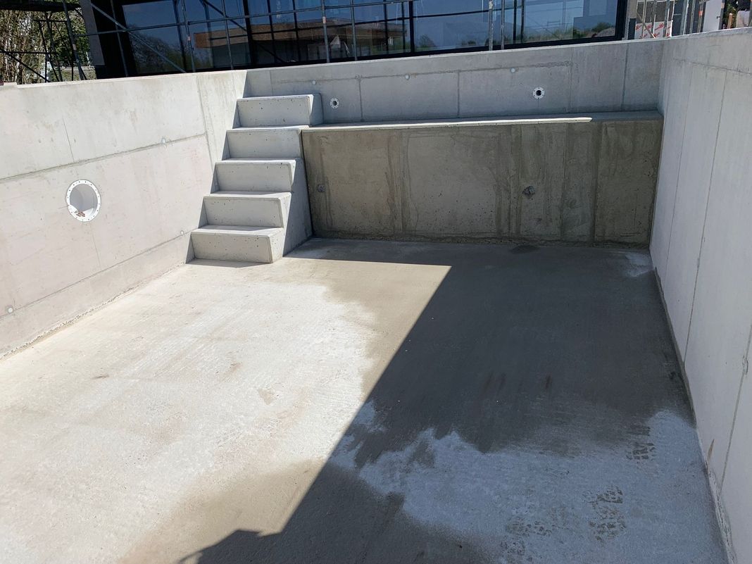 Innenansicht eines Betonpools mit integrierter Treppe